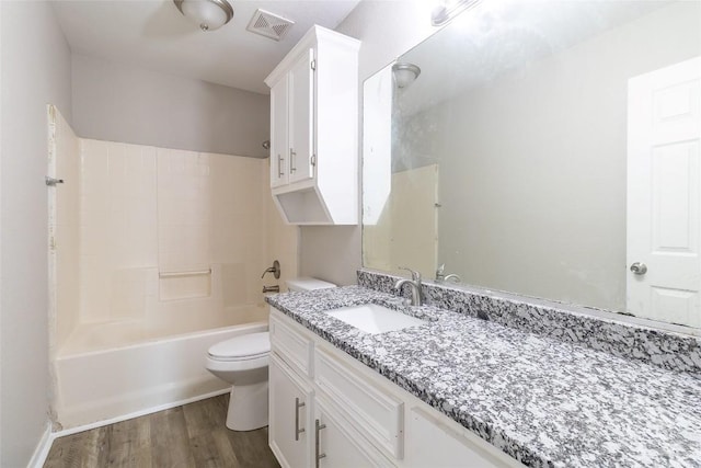 706 Brown St, Lampasas, TX 76550 - bathroom featuring vanity, wood finished floors, and bathing tub / shower combination