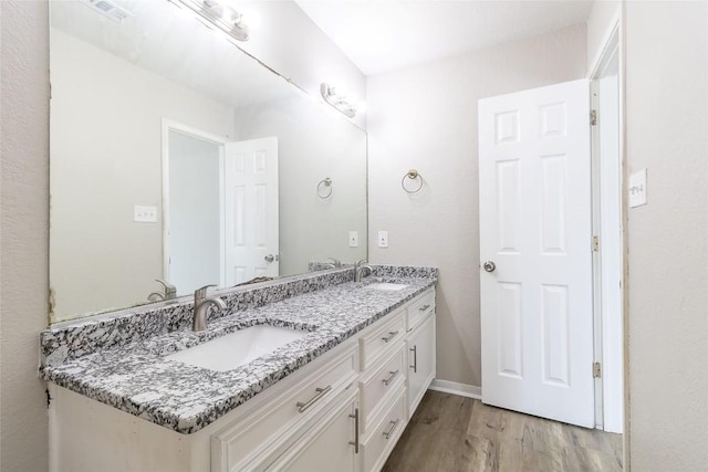 706 Brown St, Lampasas, TX 76550 - bathroom with wood finished floors and double vanity