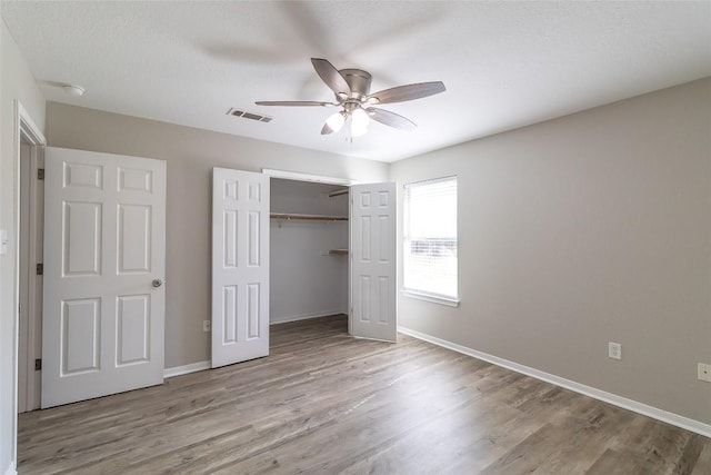 706 Brown St, Lampasas, TX 76550 - unfurnished bedroom with wood finished floors, a closet, and ceiling fan
