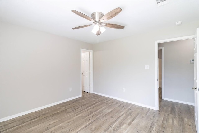 706 Brown St, Lampasas, TX 76550 - spare room featuring wood finished floors, ceiling fan, and a smoke detector