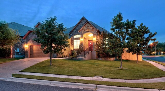 100 Crystal Cv, Round Rock, TX 78664 - view of front facade featuring concrete driveway, a front lawn, stone siding, and a garage