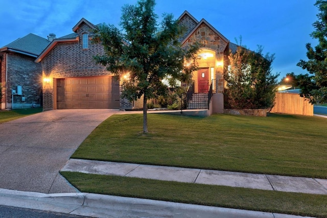 100 Crystal Cv, Round Rock, TX 78664 - view of front facade featuring concrete driveway, stone siding, an attached garage, and brick siding