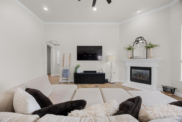 100 Crystal Cv, Round Rock, TX 78664 - living area featuring arched walkways, ceiling fan, ornamental molding, a glass covered fireplace, and recessed lighting