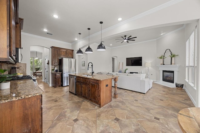 100 Crystal Cv, Round Rock, TX 78664 - kitchen featuring arched walkways, appliances with stainless steel finishes, open floor plan, a ceiling fan, and recessed lighting