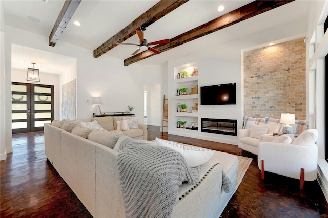 2471 George Pass, Canyon Lake, TX 78133 - living area featuring built in shelves, a ceiling fan, a glass covered fireplace, beam ceiling, and french doors