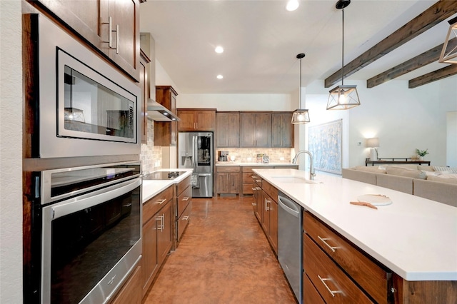 2471 George Pass, Canyon Lake, TX 78133 - kitchen featuring appliances with stainless steel finishes, decorative backsplash, concrete floors, light countertops, and open floor plan