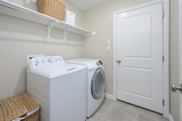 5612 Wild Foxglove Rd, Spicewood, TX 78669 - laundry room featuring washer and clothes dryer and light tile patterned flooring