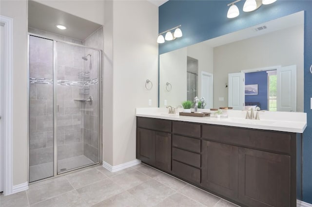 5612 Wild Foxglove Rd, Spicewood, TX 78669 - bathroom featuring a stall shower, double vanity, and tile patterned floors
