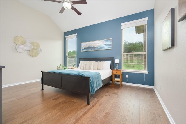 5612 Wild Foxglove Rd, Spicewood, TX 78669 - bedroom with wood finished floors, multiple windows, vaulted ceiling, and ceiling fan