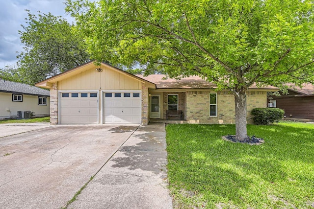 2112 Cindy Ln, Austin, TX 78727 - ranch-style home featuring an attached garage, concrete driveway, a front lawn, and brick siding