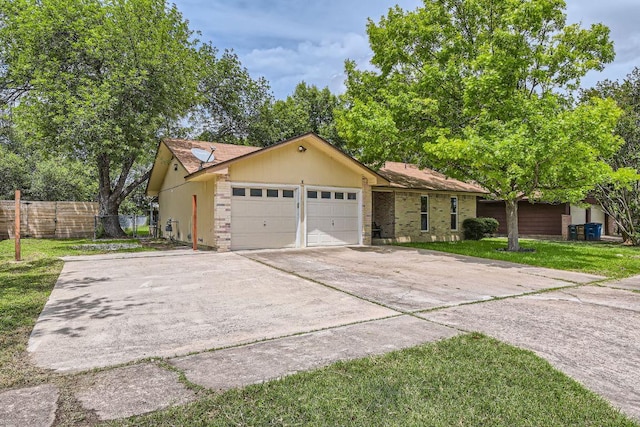 2112 Cindy Ln, Austin, TX 78727 - single story home featuring a garage, concrete driveway, and brick siding