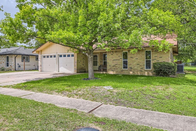 2112 Cindy Ln, Austin, TX 78727 - ranch-style home with an attached garage, driveway, and a front lawn