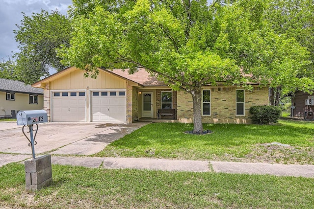2112 Cindy Ln, Austin, TX 78727 - ranch-style house with a garage, concrete driveway, a front yard, and brick siding