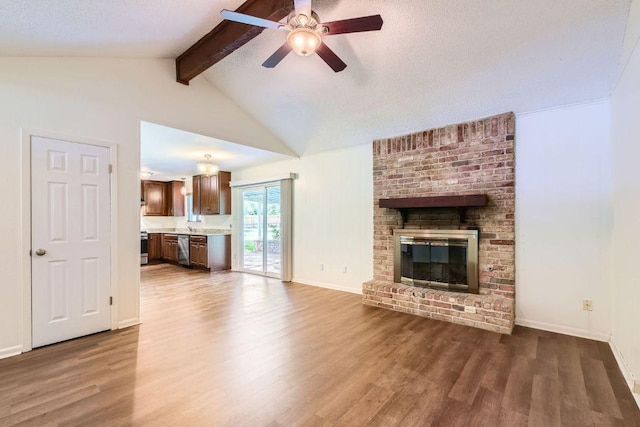 2112 Cindy Ln, Austin, TX 78727 - unfurnished living room featuring wood finished floors, a ceiling fan, and a fireplace