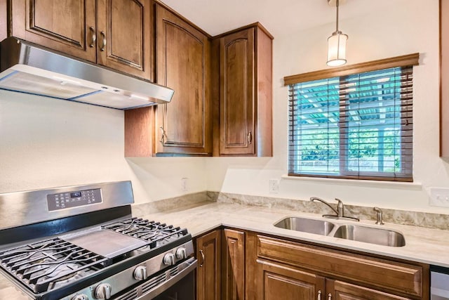 2112 Cindy Ln, Austin, TX 78727 - kitchen with gas range, under cabinet range hood, light countertops, and decorative light fixtures