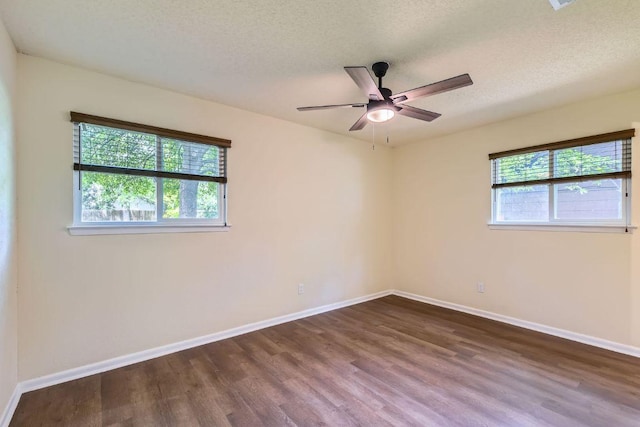 2112 Cindy Ln, Austin, TX 78727 - empty room featuring healthy amount of natural light, wood finished floors, ceiling fan, and a textured ceiling