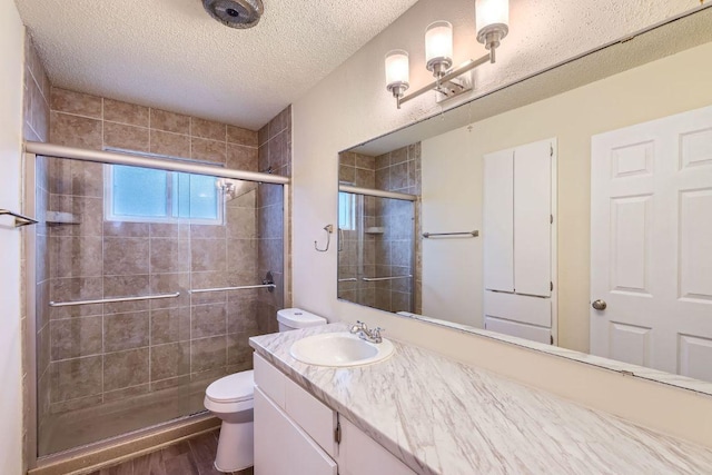 2112 Cindy Ln, Austin, TX 78727 - full bathroom with a shower stall, wood finished floors, vanity, and a textured ceiling