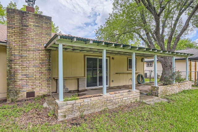 2112 Cindy Ln, Austin, TX 78727 - back of property with a chimney, a patio area, and a metal roof