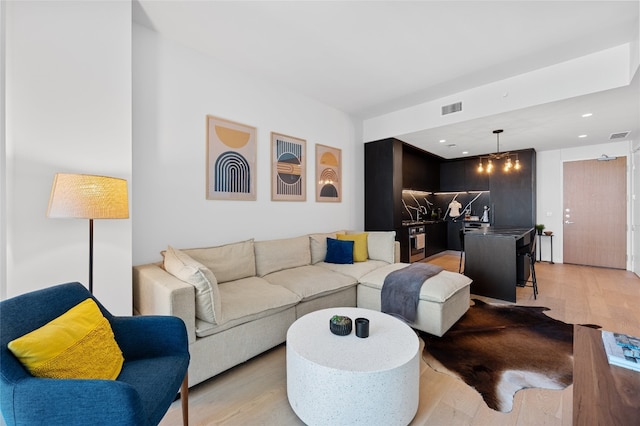 44 E Ave Unit 1404, Austin, TX 78701 - living room with light wood-style flooring and recessed lighting