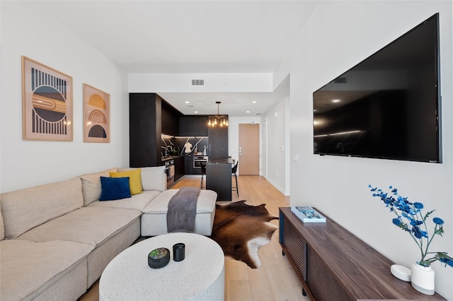 44 E Ave Unit 1404, Austin, TX 78701 - living area featuring light wood-type flooring, a chandelier, and recessed lighting