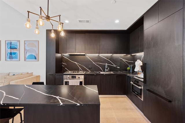44 E Ave Unit 1404, Austin, TX 78701 - kitchen featuring oven, dark countertops, backsplash, modern cabinets, and recessed lighting