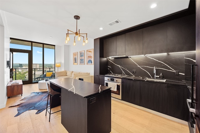 44 E Ave Unit 1404, Austin, TX 78701 - kitchen featuring stainless steel appliances, floor to ceiling windows, decorative backsplash, dark countertops, and open floor plan