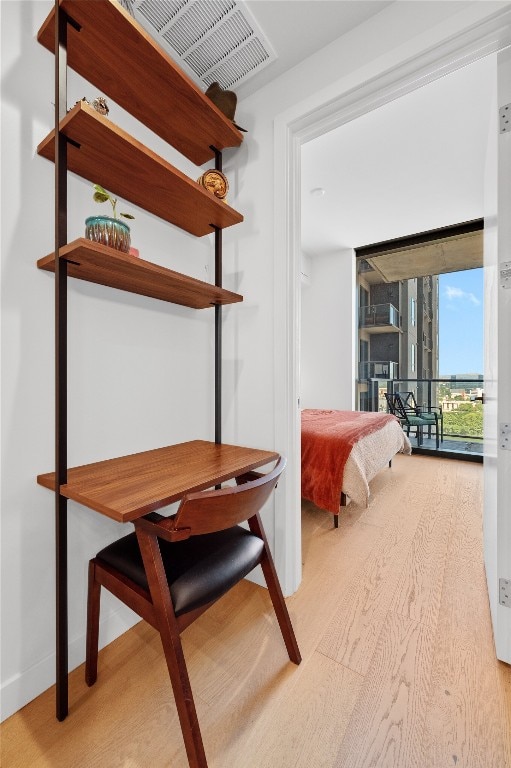 44 E Ave Unit 1404, Austin, TX 78701 - bedroom featuring wood finished floors