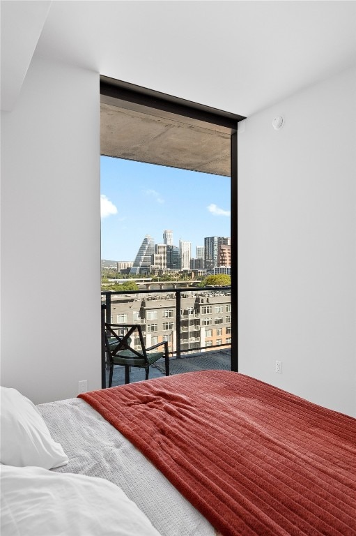 44 E Ave Unit 1404, Austin, TX 78701 - bedroom featuring a city view, a wall of windows, and access to outside