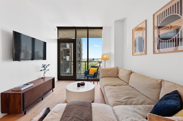44 E Ave Unit 1404, Austin, TX 78701 - living room featuring light wood finished floors and a wall of windows