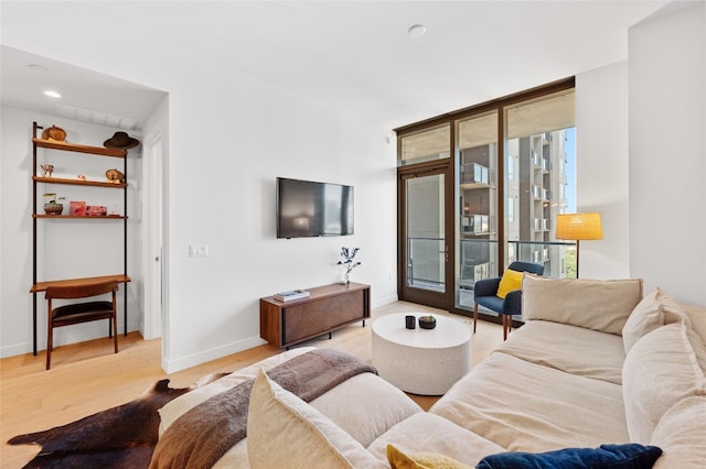 44 E Ave Unit 1404, Austin, TX 78701 - living area with light wood-style floors, french doors, and recessed lighting