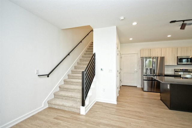 7601 Cooper Ln Unit 25, Austin, TX 78745 - kitchen featuring stainless steel appliances, light brown cabinets, recessed lighting, light wood finished floors, and tasteful backsplash