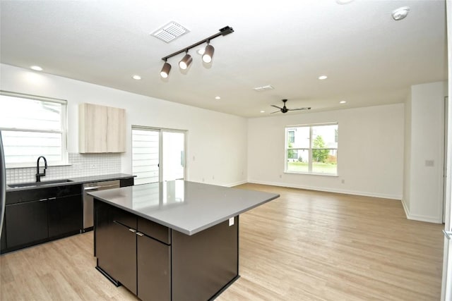 7601 Cooper Ln Unit 25, Austin, TX 78745 - kitchen featuring dishwasher, a kitchen island, a ceiling fan, light wood-style flooring, and recessed lighting