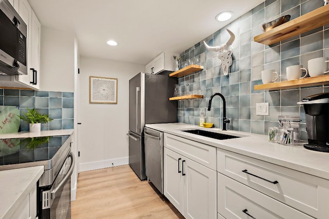 1206 Hollow Creek Dr Unit 3, Austin, TX 78704 - kitchen featuring appliances with stainless steel finishes, open shelves, tasteful backsplash, white cabinetry, and recessed lighting