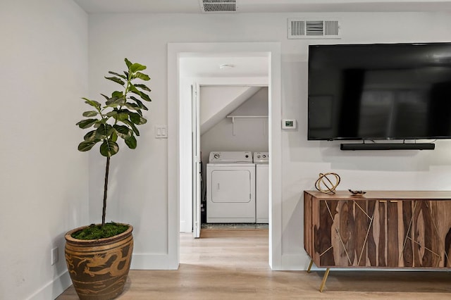 1206 Hollow Creek Dr Unit 3, Austin, TX 78704 - laundry room with independent washer and dryer and wood finished floors