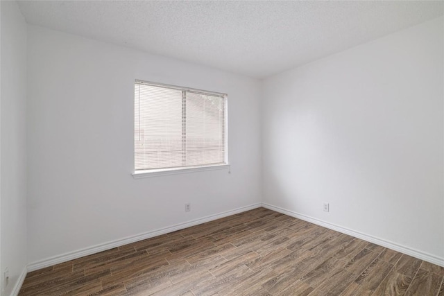 9206 Kempler Dr, Austin, TX 78748 - spare room with wood finished floors and a textured ceiling