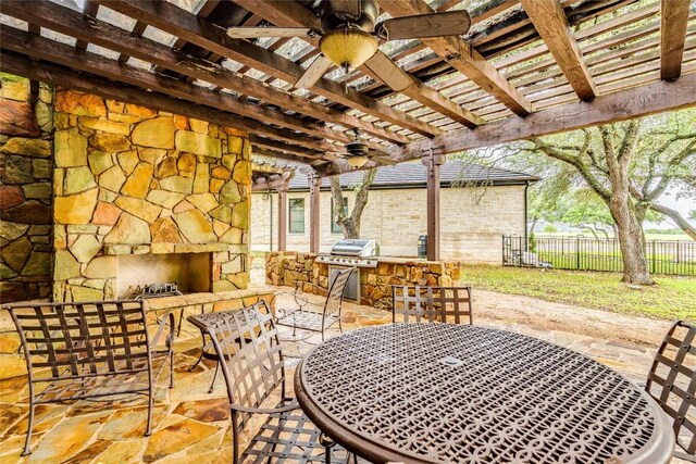 171 Oak Grove Cv, Georgetown, TX 78628 - view of patio with a fireplace, ceiling fan, area for grilling, a pergola, and outdoor dining area