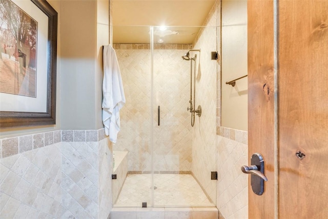 171 Oak Grove Cv, Georgetown, TX 78628 - bathroom with a stall shower and tile walls
