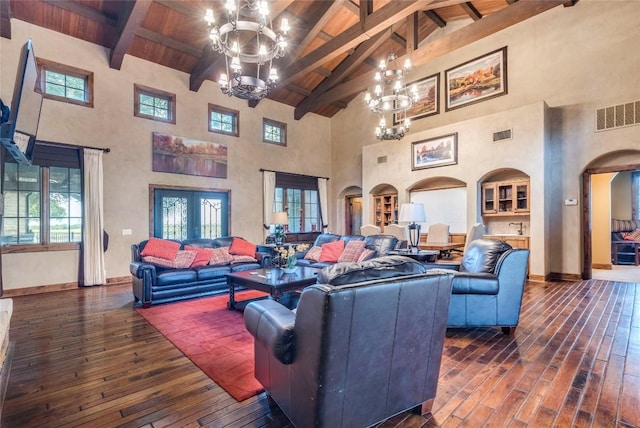171 Oak Grove Cv, Georgetown, TX 78628 - living room with high vaulted ceiling, a chandelier, dark wood-style flooring, arched walkways, and a wood ceiling with exposed beams