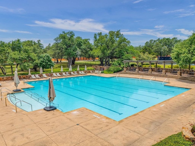 171 Oak Grove Cv, Georgetown, TX 78628 - community pool featuring a patio and view of scattered trees