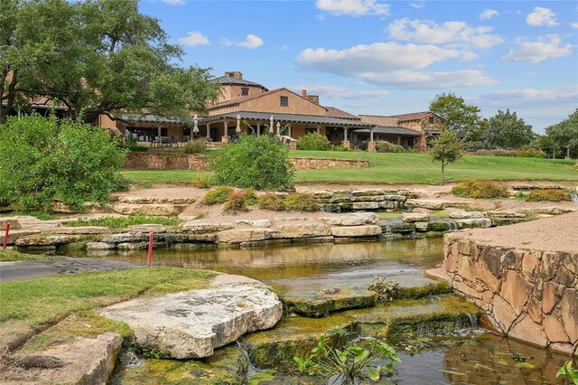 171 Oak Grove Cv, Georgetown, TX 78628 - view of community with a lawn and a garden pond