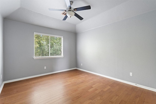 908 Golden Palomino Ct, Austin, TX 78732 - spare room with wood finished floors, a ceiling fan, and vaulted ceiling