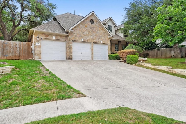 908 Golden Palomino Ct, Austin, TX 78732 - view of front facade featuring stone siding, an attached garage, driveway, and a shingled roof