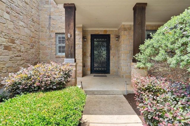 908 Golden Palomino Ct, Austin, TX 78732 - doorway to property featuring stone siding and covered porch