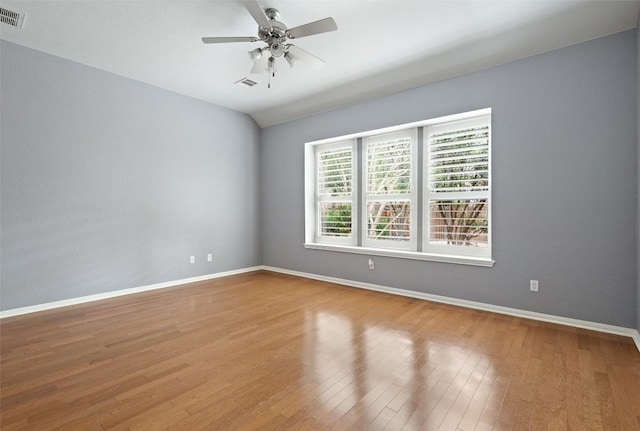 908 Golden Palomino Ct, Austin, TX 78732 - empty room featuring wood finished floors, ceiling fan, and vaulted ceiling