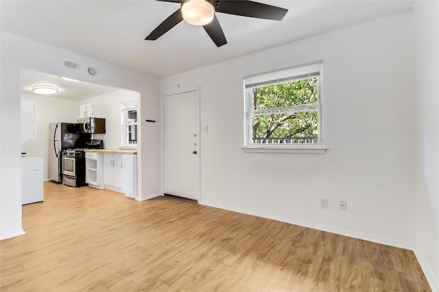 2401 Manor Rd Unit 210, Austin, TX 78722 - unfurnished living room featuring light wood-style floors and a ceiling fan