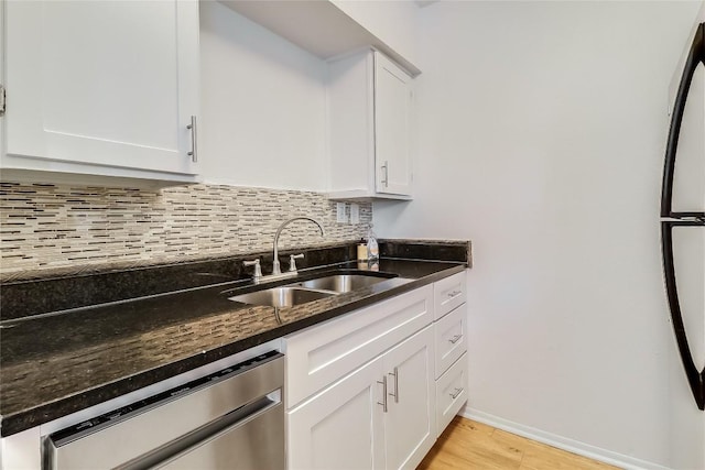 2401 Manor Rd Unit 210, Austin, TX 78722 - kitchen with dishwasher, decorative backsplash, light wood-style floors, and white cabinets