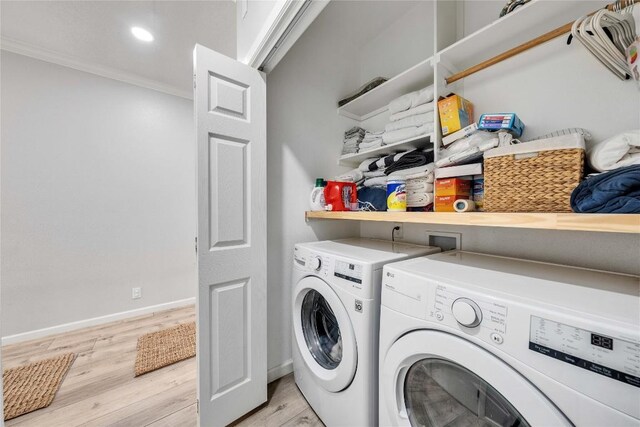 203 Sailors Run, Lakeway, TX 78734 - washroom with washer and dryer, ornamental molding, and light wood-style flooring