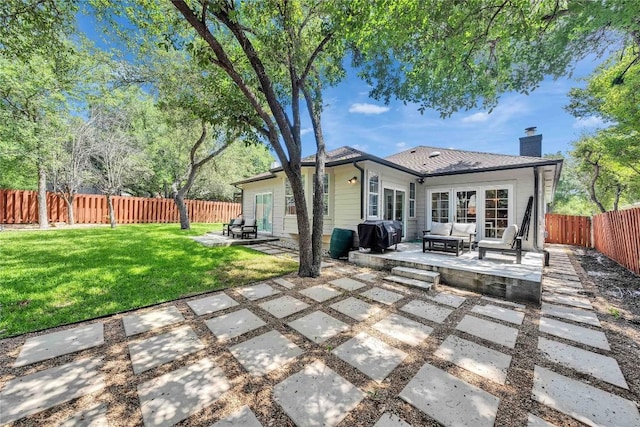 203 Sailors Run, Lakeway, TX 78734 - back of property with a patio, a chimney, a fenced backyard, and an outdoor living space