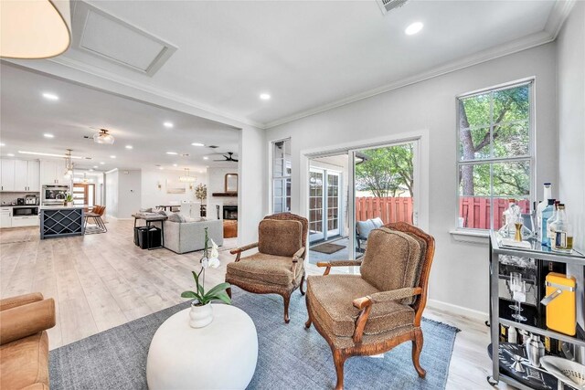 203 Sailors Run, Lakeway, TX 78734 - living area featuring ornamental molding, recessed lighting, light wood-type flooring, and attic access