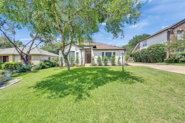 203 Sailors Run, Lakeway, TX 78734 - view of front facade with a front yard and brick siding